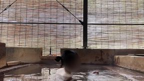 japanese girl bathing in a mixed outdoor bath at a hot spring inn