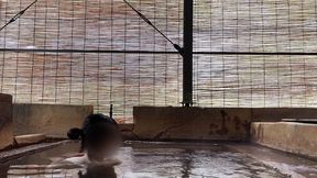 japanese girl bathing in a mixed outdoor bath at a hot spring inn