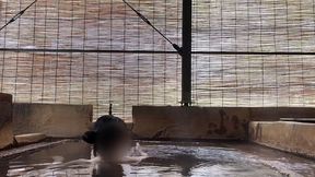 japanese girl bathing in a mixed outdoor bath at a hot spring inn