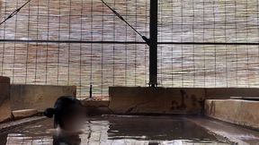 japanese girl bathing in a mixed outdoor bath at a hot spring inn