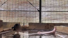 japanese girl bathing in a mixed outdoor bath at a hot spring inn