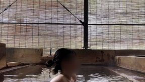 japanese girl bathing in a mixed outdoor bath at a hot spring inn
