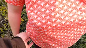 Happy woman slaps her big tits in nature