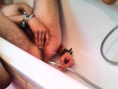 Bi-guy using shower head, squirting water, enema