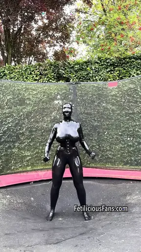 Miss Fetilicious jumping in latex catsuit