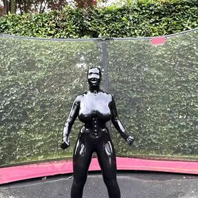 Miss Fetilicious jumping in latex catsuit