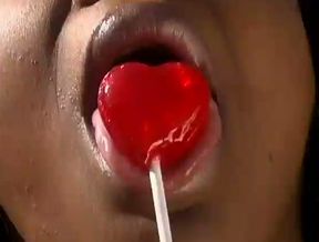 Ebony hussy sucks a lollipop outdoors and takes a ride on a BBC