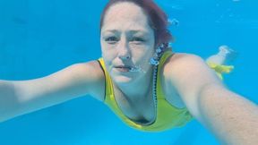 Lets swim and blow bubbles while wearing a yellow dress underwater
