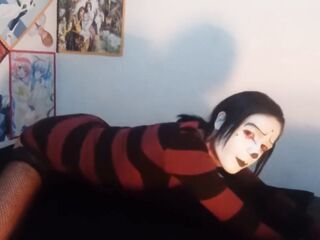 Gothic femboy in constricted costume and underware shows off her butt