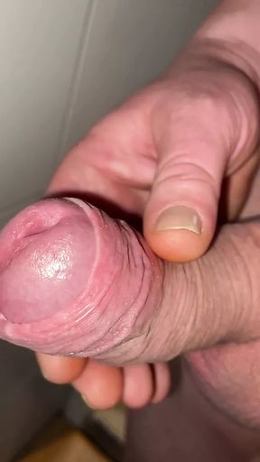 Close-up slowly revealing foreskin and cock head