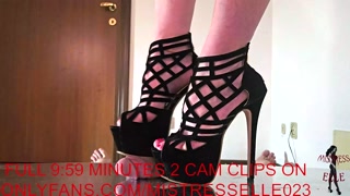 Mistress Elle grinds her slave's cock in her platform high heel sandals