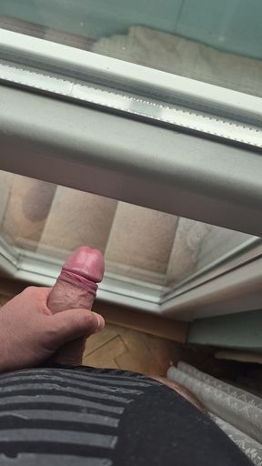 A thick and meaty Bulgarian cock is hard in front of the window