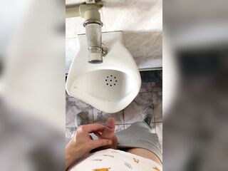 Dude pissing with large uncut ramrod in public water closet in slow motion POV