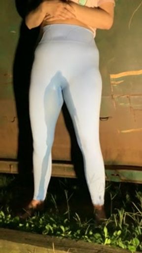 Slut drenches her yoga pants in piss outdoors