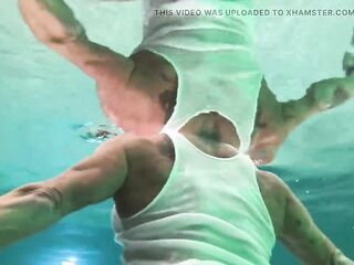 Amazon Kandy Flexes Her Massive Biceps in Her Hotel Pool