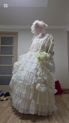 A man dressed as a woman in a wedding dress is being seductive.