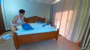 Nudist housekeeper Regina Noir makes the bedding in the bedroom  Naked maid  Naked housewife  1