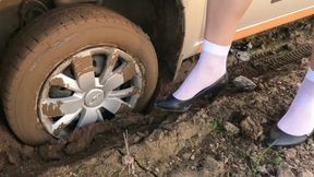 Sexy girl in retro outfit and nylon pantyhose and socks stuck hard in car in deep soft mud