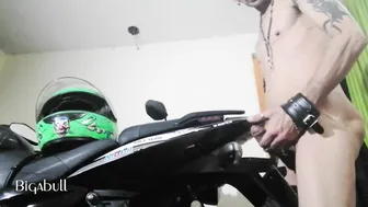 Tattooed mature guy jerks his uncut cock on a motorcycle