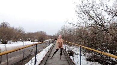 Naked girl walking on the bridge