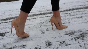 Girl on Louboutin high heels pumps walking on very slippery ice, in louboutin walking on ice