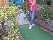 Small petite girl playing golf and not doing good at it