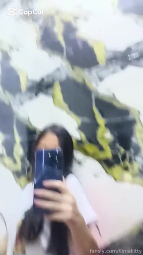 Chinese innocent girl fans her shirt while looking pretty cute