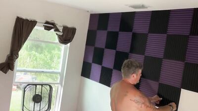 Fat guy films himself naked putting sound insulation in a room