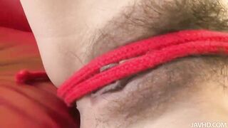 Suzuka plays with her sweet pussy with a red nylon rope as she moans and groans