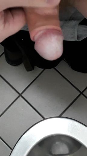 Playing with cock in a public toilet