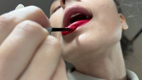 Nastya paints eyelashes and lips with mouth open