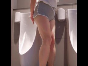 A horny slut enjoys risky pleasure in public men's room, anal masturbates on men's toilets and cums with the door open.