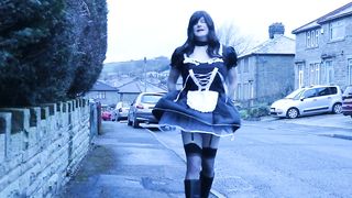 French maid crossdresser outdoors on a council estate