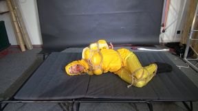 Ms Ungeniert bound and gagged in a shiny nylon Rainsuit trying to get free