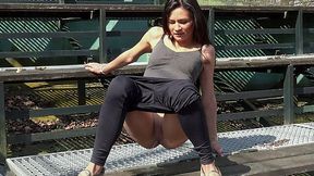 Sporty exciting brunette teenie pisses on the fan zone of the field