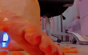 Woman worshipfully crushes tangerines on her feet