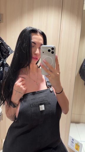 Woman in overalls taking selfie