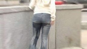 Just an amateur brunette chick in jeans peeing in her pants in public