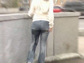 Just an amateur brunette chick in jeans peeing in her pants in public