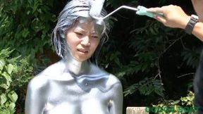 It gave a silver body paint video shot outside