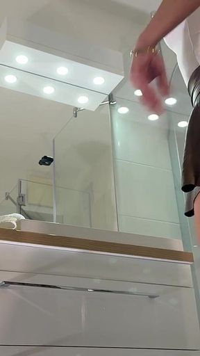Miniskirt Lover Raver Girl Reveals Her Piercing on Her Pussy in the Bathroom by Lifting Her Short Skirt