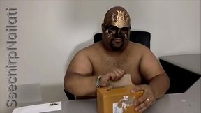 A brown man unboxing a new toy.