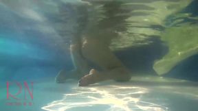 Elegant and flexible babe, swimming underwater in the outdoor swimming pool. 3 1