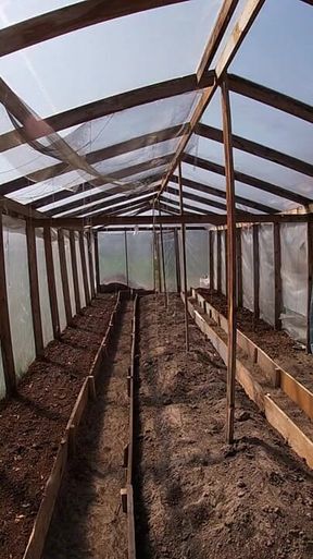 Nude house wife working in the greenhouse