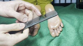 Tickling girlfriend's feet in bed face down with a comb and oil