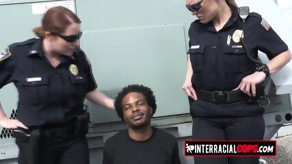 Slutty female cops are ready to fuck with this horny black suspect before taking him to jail.