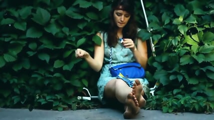 Adorable Brunette Hippy Gal Sits In Shrubs And Her Dirty Feet While Smoking