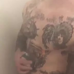 Tattooed muscle soldier in the shower