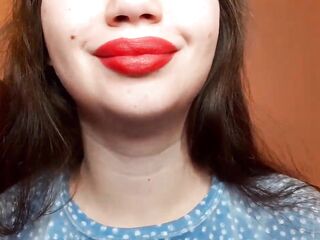 Natural lips with red lipstick smokin' a cigarette in close up