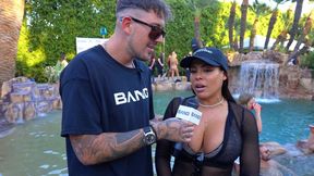 Inked bombshell shows off large boobs at pool party game show